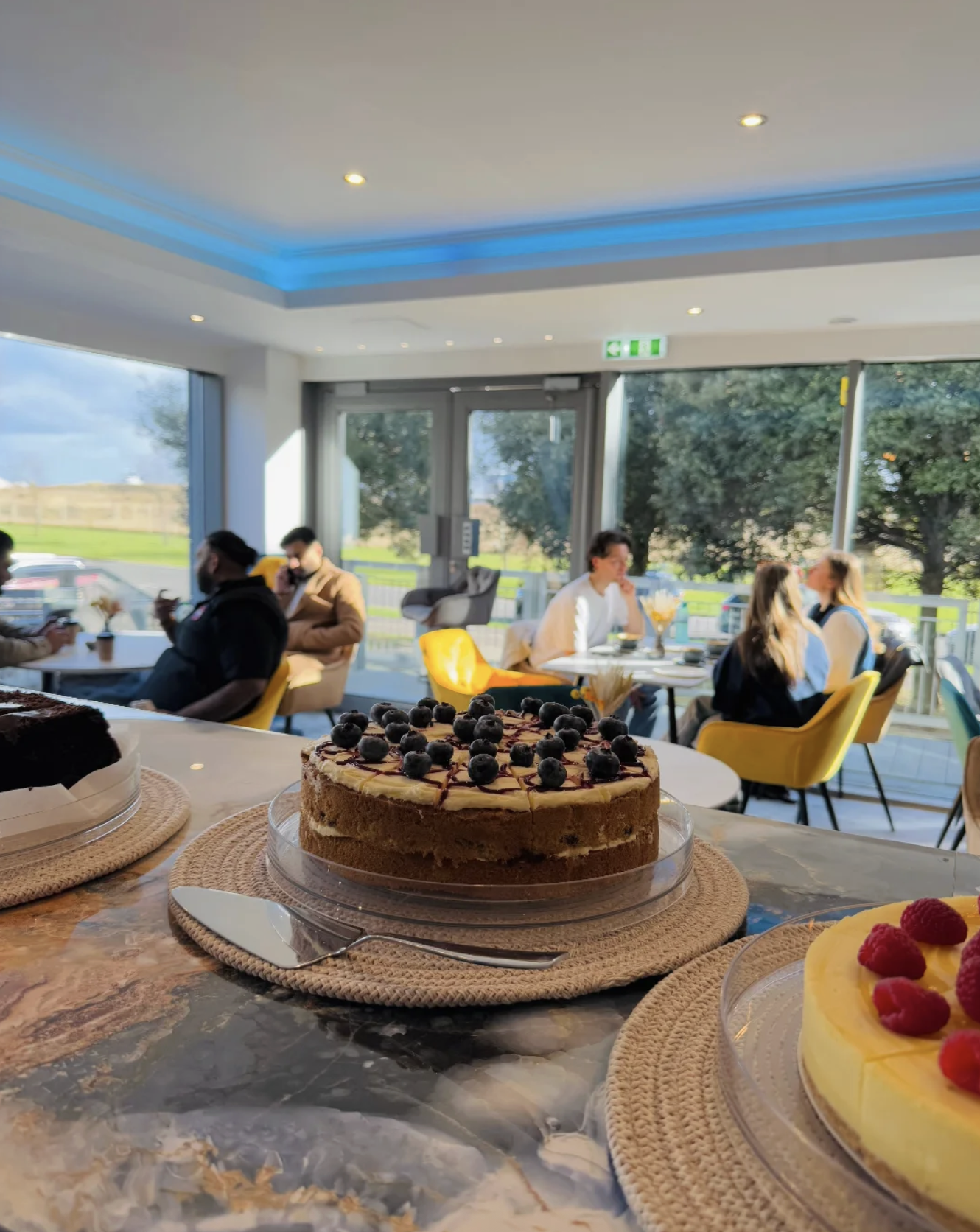 Blue Harbour Café interior with cake display and customers